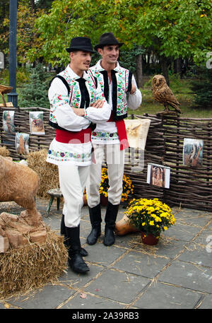 Chisinau, Moldova - October 5, 2019: Two young men in a traditional Balkan costume at a festival in Chisinau, the capital of Moldova. Rest in the park Stock Photo