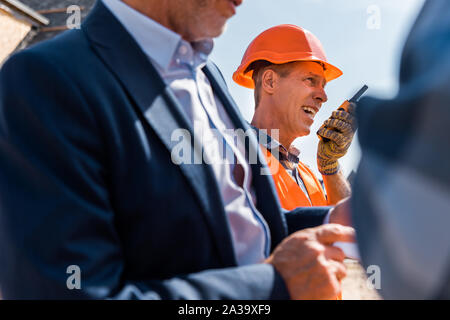 selective focus of architect using walkie talkie near businessman Stock Photo