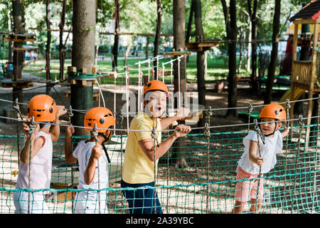 surprised boy near cute multicultural friends in helmets Stock Photo