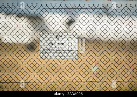 Brisbane, Australia July 26, 2019 A Commonwealth of Australia security sign on the fence at Brisbane Airport, warning of penalties for trespassing. Stock Photo