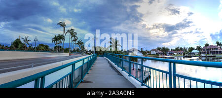 Dark clouds over Herbert R. Savage bridge, over Savage Pass, at the entrance of Marco Island, Naples, Florida Stock Photo