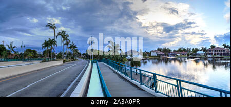 Dark clouds over Herbert R. Savage bridge, over Savage Pass, at the entrance of Marco Island, Naples, Florida Stock Photo