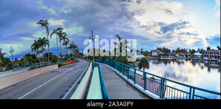 Dark clouds over Herbert R. Savage bridge, over Savage Pass, at the entrance of Marco Island, Naples, Florida Stock Photo