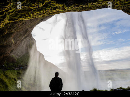 Seljalandsfoss is a waterfall that drops197 feet from a cliff which allows people to hike behind the waterfall. It is on the southern coast of Iceland Stock Photo