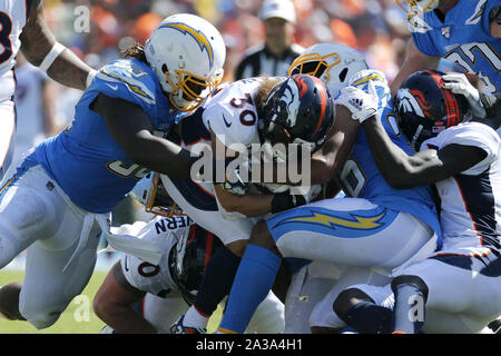 Denver, Colorado, USA. 1st Dec, 2019. Broncos RB PHILLIP LINDSAY starts to  take off his jersey to exchange with a Chargers player during the end of  the game at Empower Field At