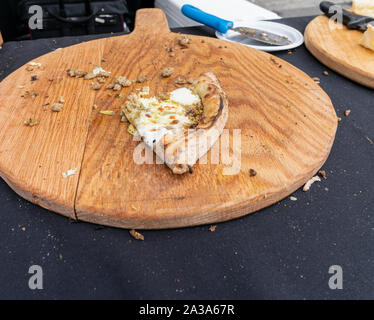 New York, NY - October 6, 2019: Slice of coal owen pizza on display during New York Pizza Festival on Crescent Avenue in the Bronx Stock Photo