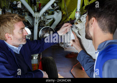 men working on airplane engine Stock Photo