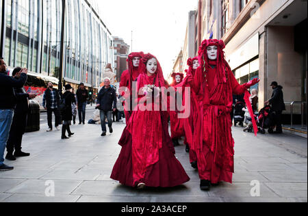 London, UK. 6th October 2019. Extinction Rebellion walk along Oxford Street at the start of two weeks of protests in which they plan to block every single road into central London. Other protest are expected in about 60 cities around the world. Credit: Stuart Boulton/Alamy