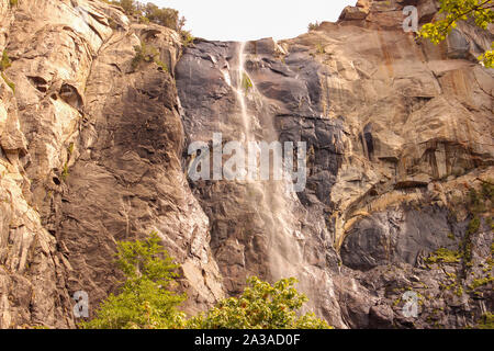 Wind blows the falling water sideways in Bridalveil Fall, Yosemite National Park, California, USA Stock Photo