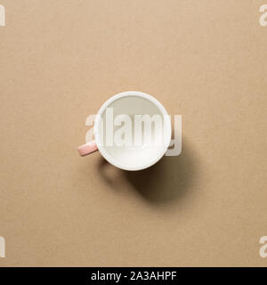 Empty mug cup on brown background Stock Photo