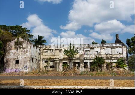 Wall Graffiti and Abandoned Residential Building Ruins on Amador Causeway Pedestrian Walkway near Panama Canal in Panama City Stock Photo
