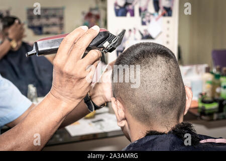 The Crew Cut hairstyle. Short and Easy hair for men. barber making haircut of man in barbershop. Stock Photo