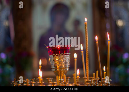 Church candles on the background of icons. Religion. Stock Photo