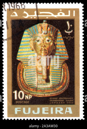 FUJEIRA - CIRCA 1966: A stamp printed in Fujeira shows  Mask of Tutankhamen with inscription and name of the series 'Stamp Centenary Exhibition, Cairo Stock Photo