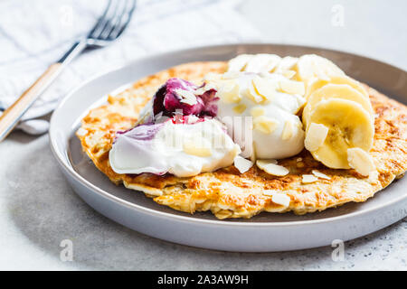 Sweet oatmeal omelette with banana and yogurt. Healthy breakfast concept. Stock Photo