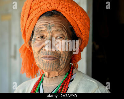 Elderly Chin Muun tribal woman ('spider woman') with traditional facial tattoo poses for the camera (head shot). Stock Photo