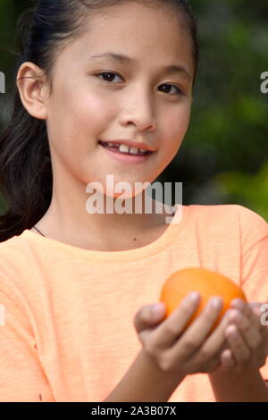 Smiling Beautiful Asian Teenage Female With An Orange Stock Photo