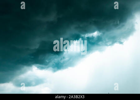 Dark sky and black clouds before rainy, Dramatic black cloud and thunderstorm .half of sky .season change Stock Photo