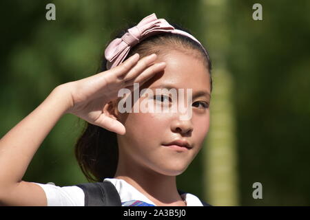 A Youthful Diverse Female Student Saluting Stock Photo