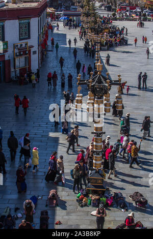 Tibetan pilgrims circumambulate around and prostrate themselves in front of the Jokhang Temple in Barkhor Square in Lhasa, Tibet. Stock Photo