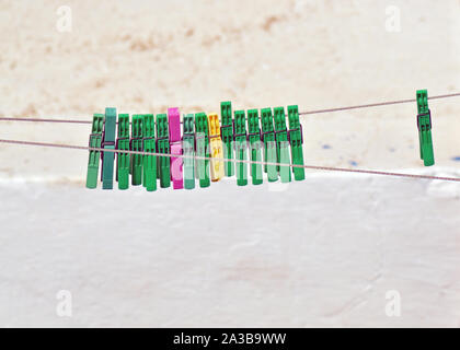 Background of colored clothespins on wire Stock Photo