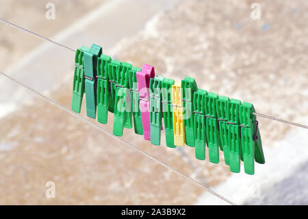 Background of colored clothespins on wire Stock Photo