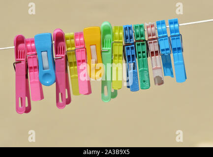 Background of colored clothespins on wire Stock Photo