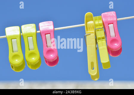 Background of colored clothespins on wire Stock Photo