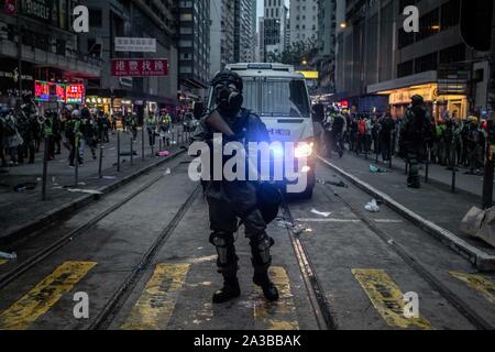 Hong Kong, China. 06th Oct, 2019. Riot police patrol the streets of Wan Chai during the demonstration.Protesters went out to demonstrate against the Anti-mask Law. Hong Kong's chief executive Carrie Lam invoked the use of the Emergency Regulations Ordinance (ERO) allowing the government to ban use of masks in public gatherings. Credit: SOPA Images Limited/Alamy Live News Stock Photo