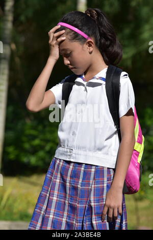 Anxious Cute Filipina School Girl Wearing School Uniform With Notebooks Stock Photo