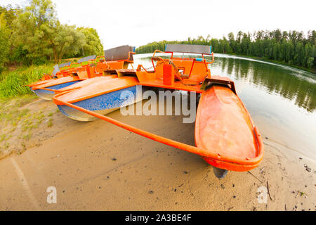 Old orange catamaran on lake. Hipster lifestyle Stock Photo