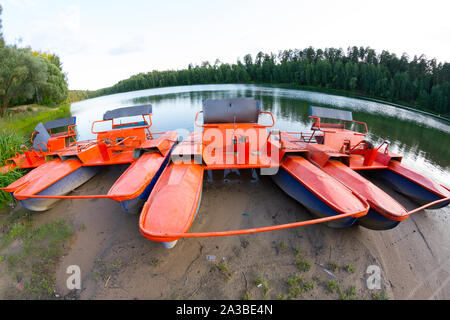 Old orange catamaran on lake. Hipster lifestyle Stock Photo