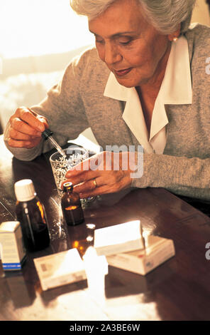 old age woman take medicines Stock Photo