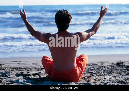 man sitting on the beach Stock Photo