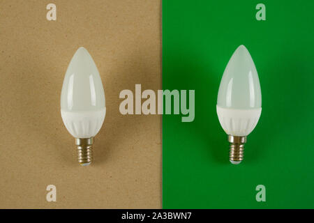 Old light bulb vs energy saving one concept Stock Photo