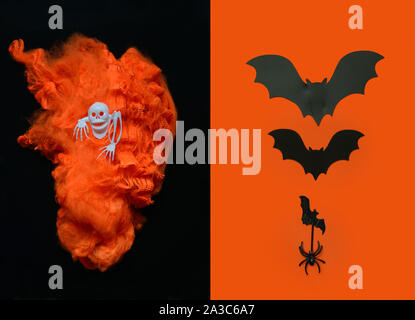 Black and orange Halloween background with orange torch in the shape of a heart, skull , bats and spider.Halloween concept. Flat lay. top view Stock Photo