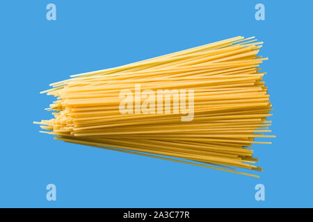 Raw Spaghetti pasta on blue background Stock Photo