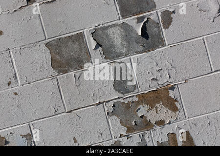 the white paint peeling off of the side of a building Stock Photo