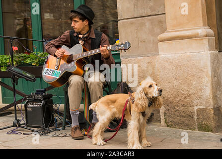 Lviv, Ukraine - May 04, 2019: Retro cross-country bicycles dedicated to the day of the city.Street musician with a dog playing a melody . Stock Photo