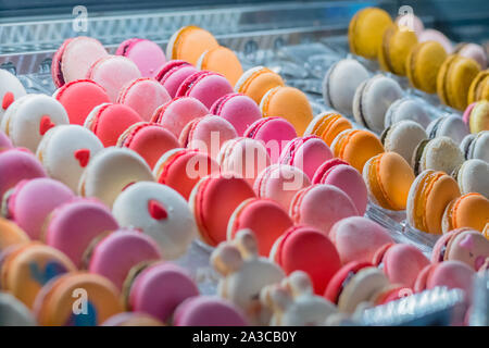 Colorful macarons for sale on counter of candy shop Stock Photo