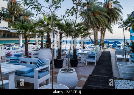 Great outdoor terrace of a restaurant with the colors of Greece in the city of Stalis in Crete Stock Photo