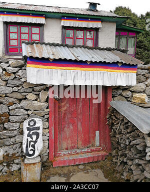 Ancient Buddhist Mani stone with engraved sacred mantra 'Om Mani Padme Hum' in Tengboche monastery; trek to Everest base camp, Sagarmatha national par Stock Photo