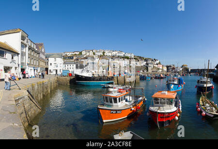 Mevagissey harbour with boats at anchor the village is within the Cornish Area of Outstanding Natural Beauty and is a popular destination for tourists Stock Photo