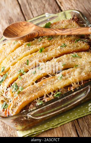 Delicious pastelon Puerto Rican banana casserole with ground beef close-up in a baking dish on the table. vertical Stock Photo