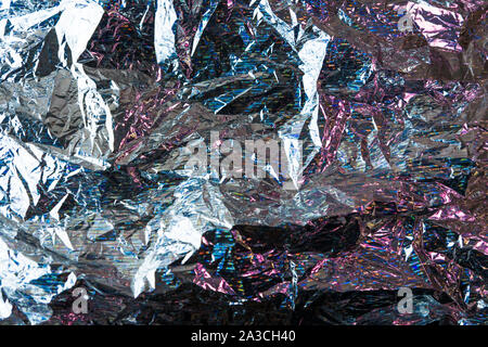 Creative photo background of crumpled foil with pink and blue highlights and shadows Stock Photo
