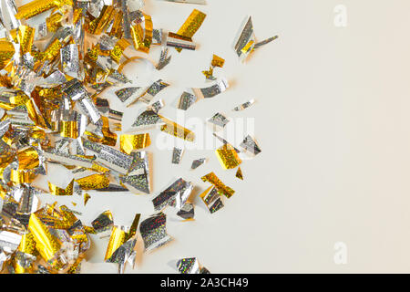 Photo background of rectangular confetti made of gold and silver foil. Place for text. Stock Photo