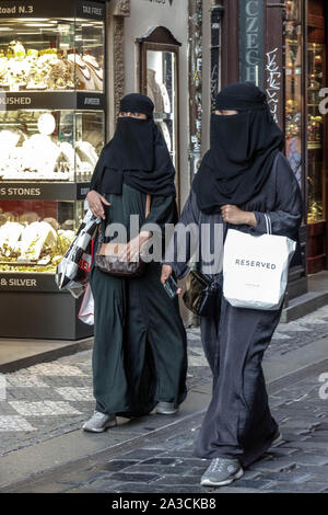 Two Arab women shopping in black abayas Niqaab Clothing Hidden Women Charles Street Prague Czech Republic Europe Women Luxury Shopping Muslim Women Stock Photo