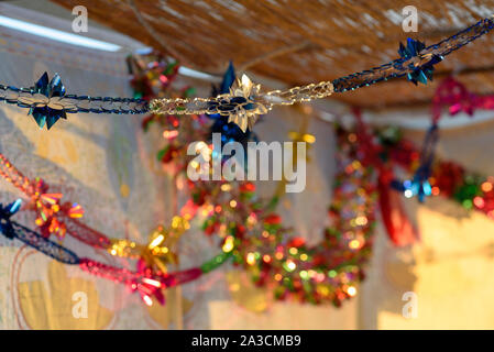 Colorful Sukkah decoration shiny garland at sunset light. Stock Photo