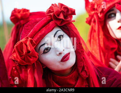 Berlin, Germany. 07th Oct, 2019. Activists of the climate movement 'Extinction Rebellion' dressed in red perform a performance at the beginning of their action week 'Block Berlin' at a blockade of the access roads to the Great Star at the Victory Column. Credit: Christophe Gateau/dpa/Alamy Live News Stock Photo
