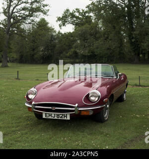 A maroon coloured E-Type Jaguar, 1969 model. Registration EHJ 82H. c1970 Photo by Tony Henshaw Archive Stock Photo